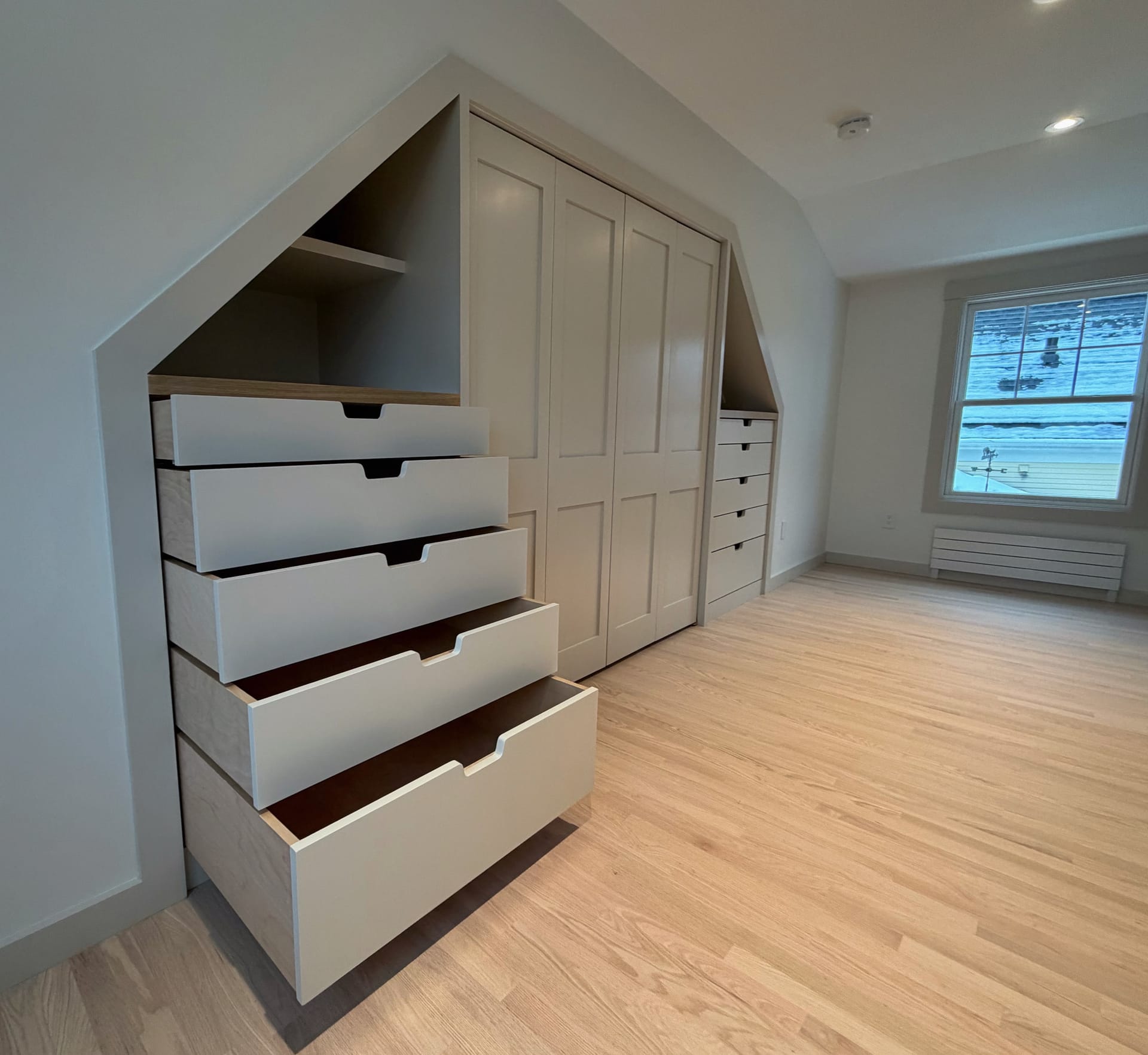 Custom built-in walk-in closet with wood shelving and drawers