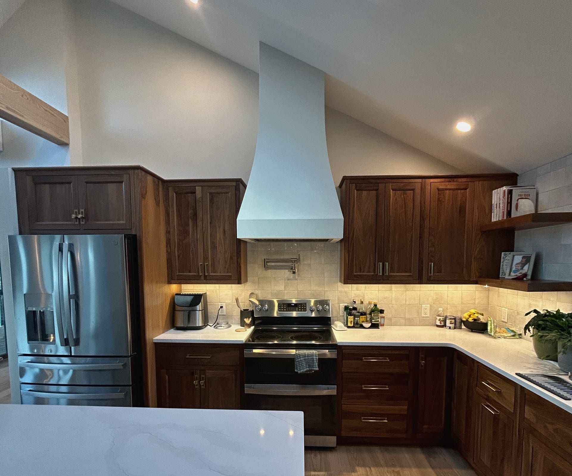 Beautiful renovated kitchen with white cabinets and hardwood floors