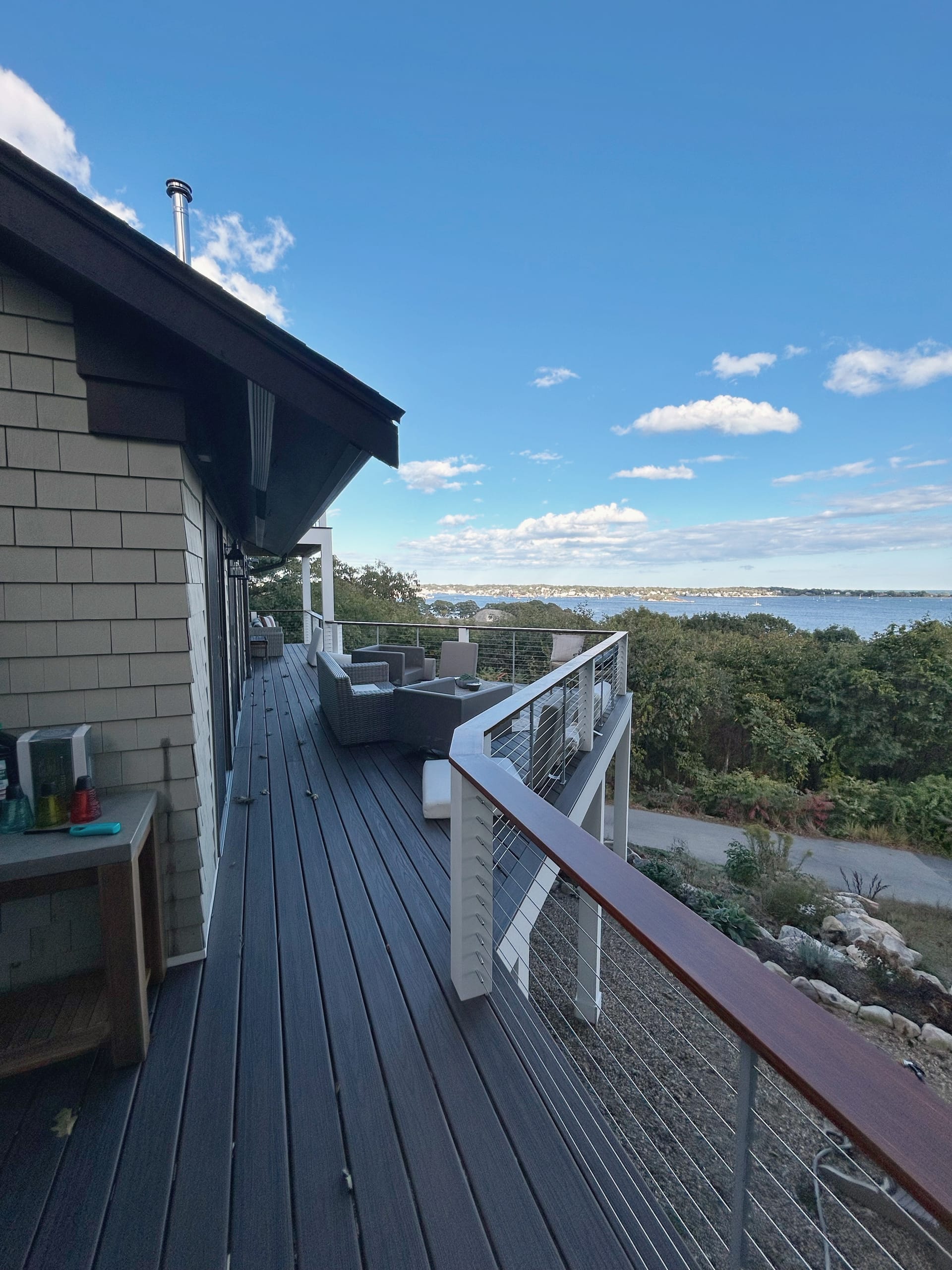 Custom outdoor deck with comfortable seating and lush landscaping